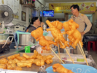 Try Pa Tong Go Ko Neng a local favorite  Fried Dough Sticks.